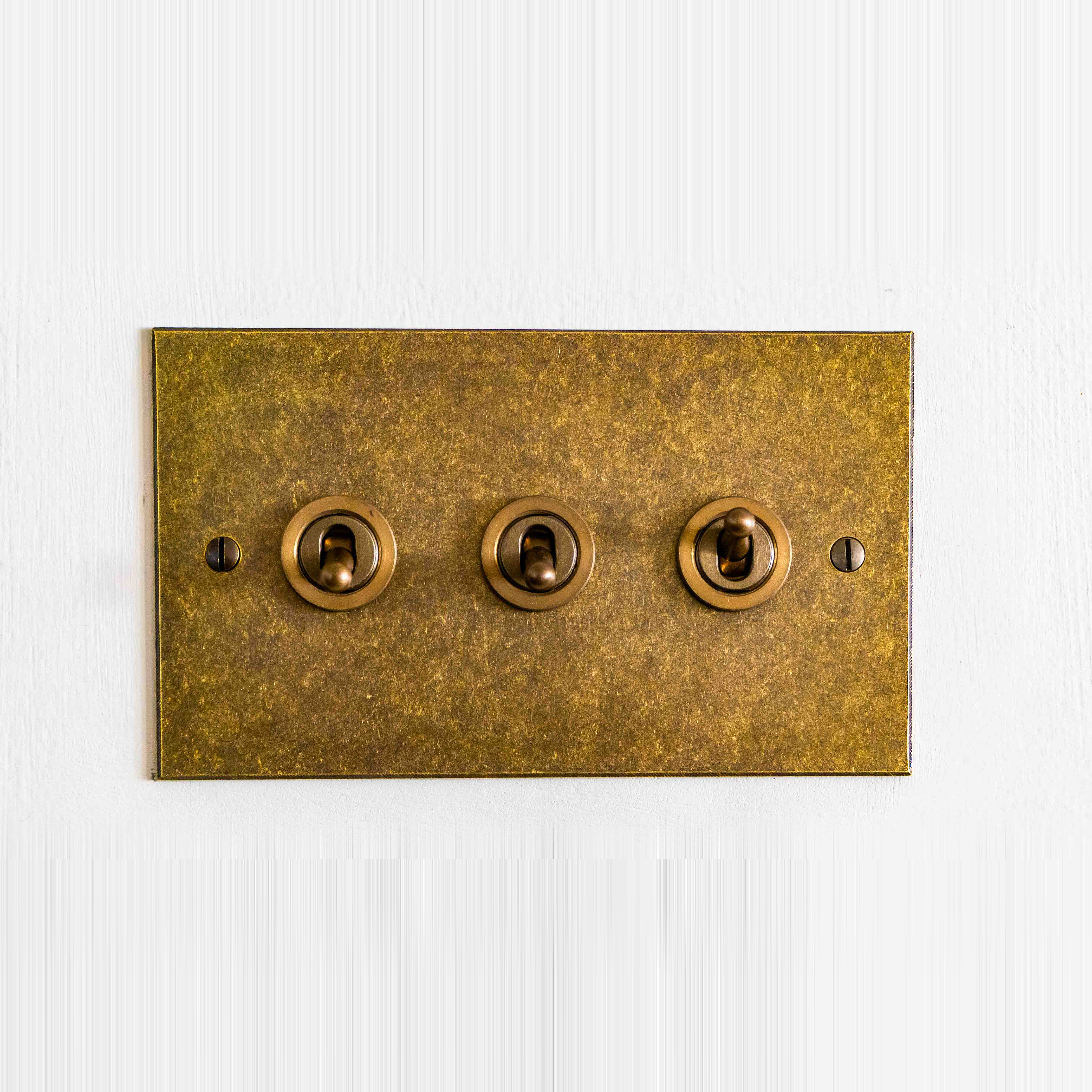 Antiqued brass toggle light switch plate
